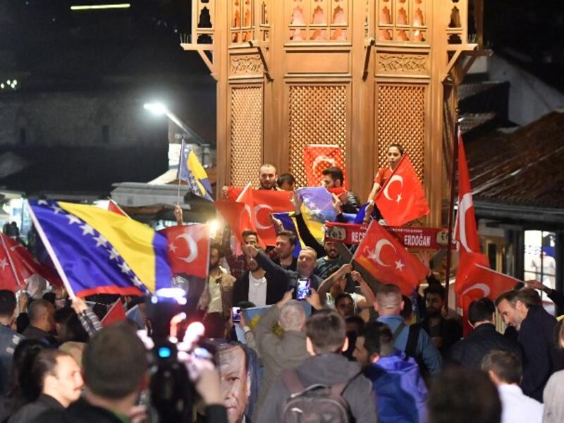 Turkish nationals, supporters of president Recep Tayyip Erdogan, currently residing in Bosnia and Herzegovina, cheer in downtown Sarajevo, late on June 24, 2018. After 15 years in office that have already transformed his country, President Recep Tayyip Erdogan is set to return to power. (STR / AFP)
