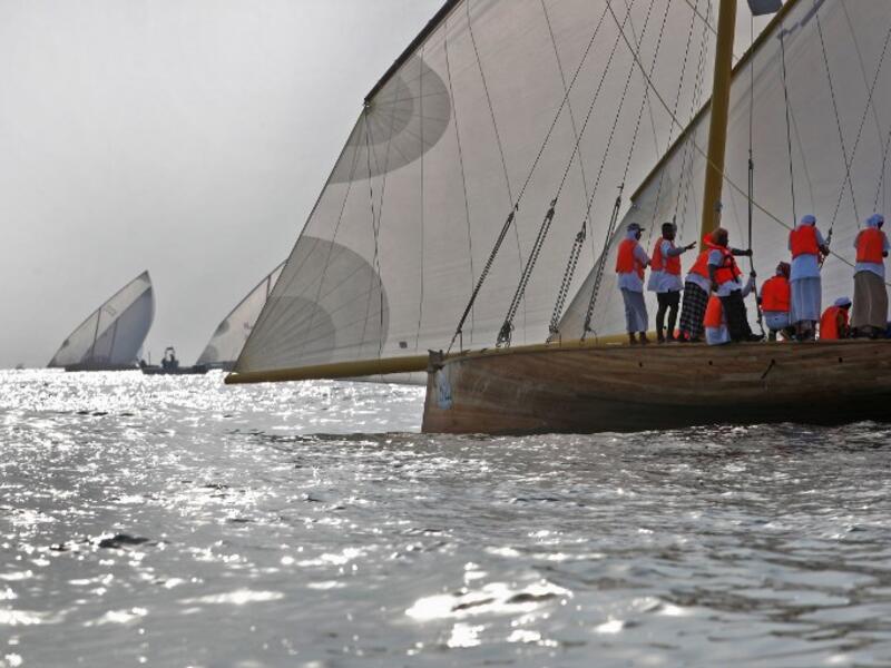 Emirati competitors sail their dhows as they take part in the Dalma Sailing Festival. (KARIM SAHIB / AFP)