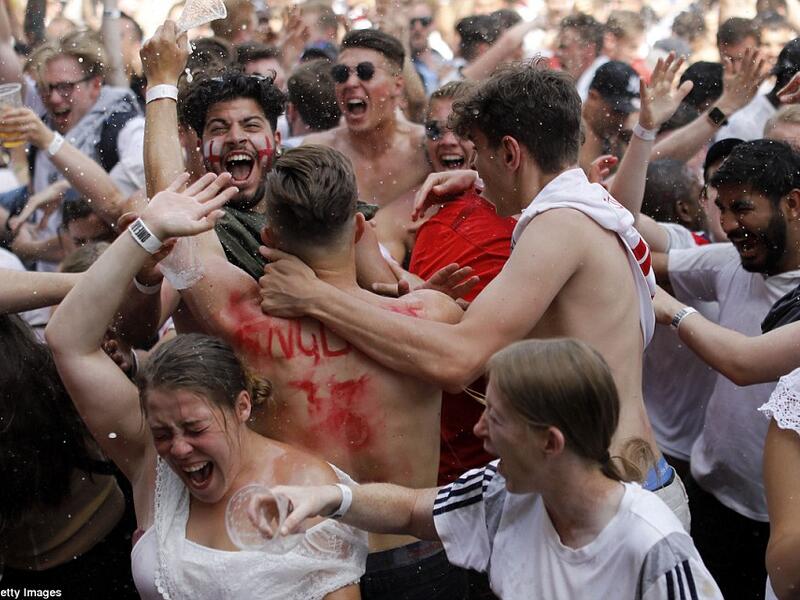 These fans in London could be seen cheering wildly and throwing beer around as Dele Alli added a second goal for England against Sweden. (AFP/ File Photo)