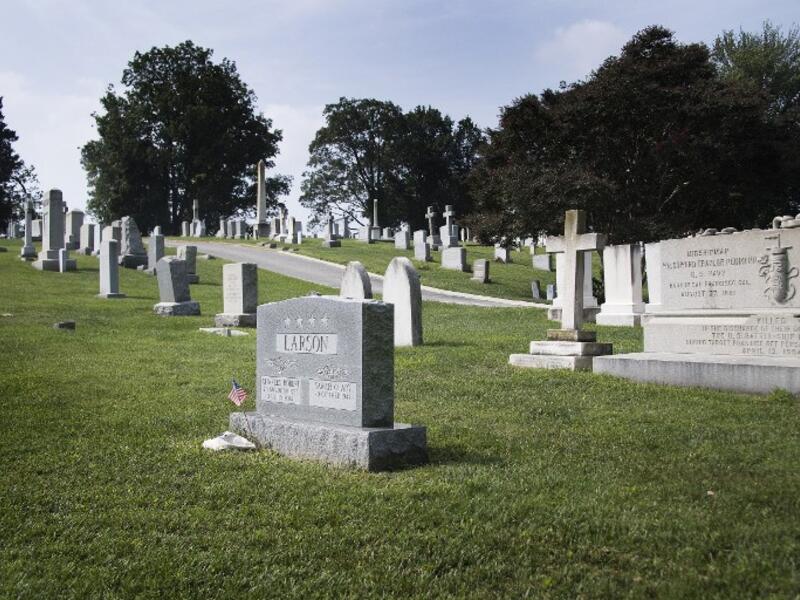 A flag is placed at the base of the tombstone of US Navy admiral Charles "Chuck" Larson at the US Naval Academy in Annapolis, Maryland, on August 24, 2018, near where US Senator John McCain will be laid to rest next. (AFP)
