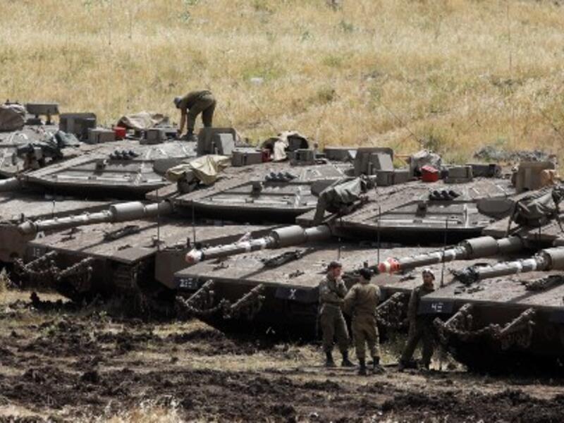 Israeli Merkava tanks are seen in a deployment area near the Syrian border in the Israel-annexed Golan Heights on May 10, 2018 (AFP)