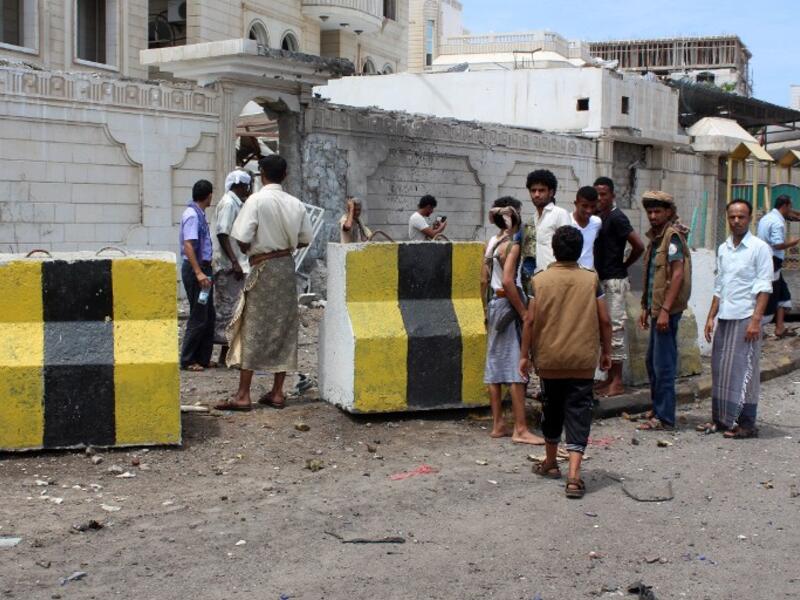 People gather at the site of a car bombing near the Foreign Ministry in Aden on Friday. (AFP/Saleh Al-Obeidi)