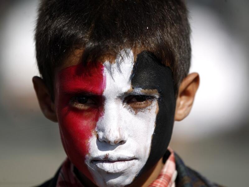 A Yemeni child, with his face painted in the colours of his national flag, looks on during an anti-US protest staged by supporters of the Huthi rebels in Sanaa on May 20, 2017. (Mohammed Huwais/AFP)