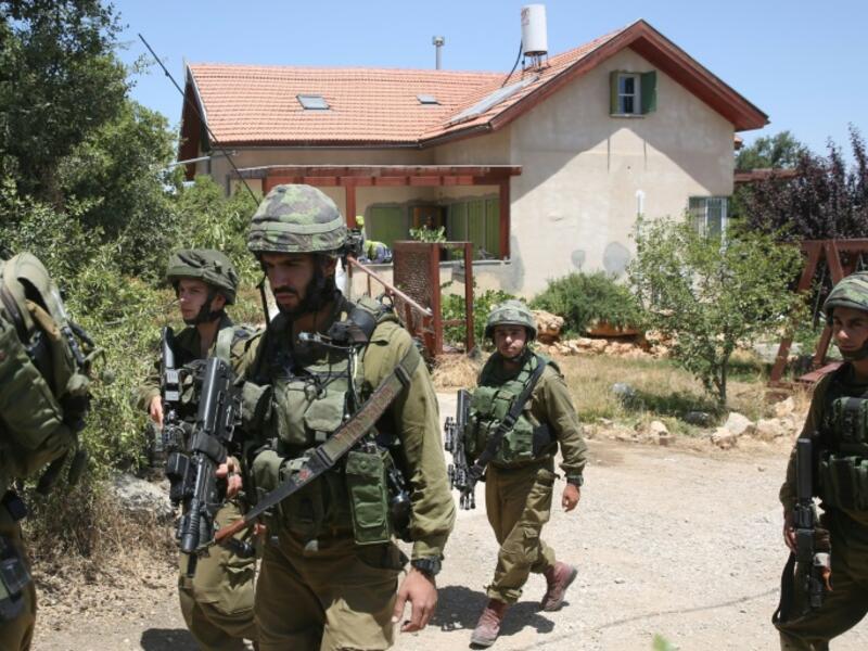 Jewish settlers with Israeli troops converged on a Palestinian town that was scene of fierce confrontations last month. (AFP/File Photo)