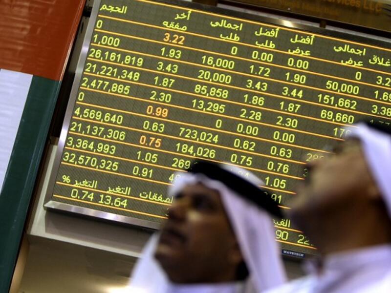 Emirati traders follow the stock market activity at the Dubai Financial Market. (Karim Sahib/ AFP)