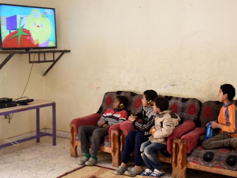 The mother stood with a poster advertising her three children for sale (AFP/File)
