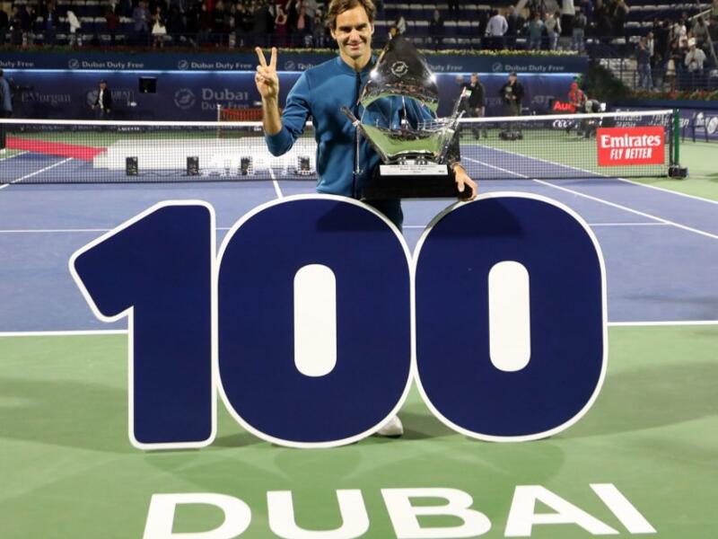 Switzerland's Roger Federer celebrates with the trophy after winning the final match at the ATP Dubai Tennis Championship in the Gulf emirate of Dubai on March 2, 2019. Roger Federer won his 100th career title when he defeated Greece's Stefanos Tsitsipas 6-4, 6-4 in the final of the Dubai Championships.
KARIM SAHIB / AFP