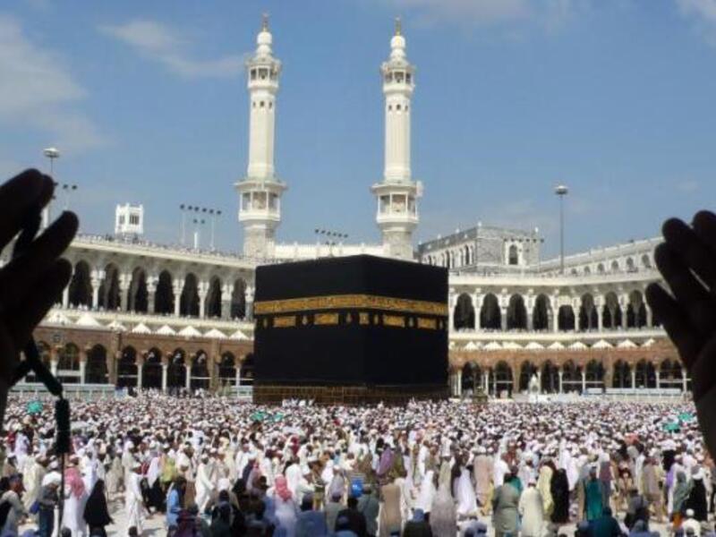 A man lifts his hands in prayer while overlooking pilgrims on Hajj. (AFP/File)