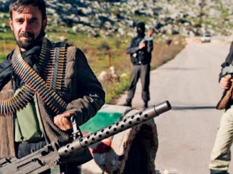 Members of the Free Syrian Army pose with weapons in Syria's Idlib. (AFP/File)