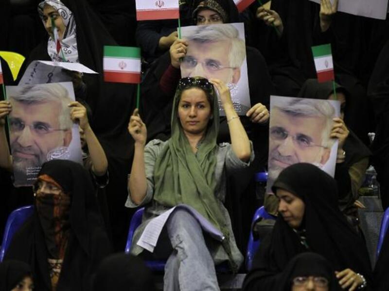 Supporters hold portraits of Iranian presidential candidate and lead nuclear negotiator Saeed Jalili during a campaign rally in Tehran on May 24 (Atta Kenare / AFP)