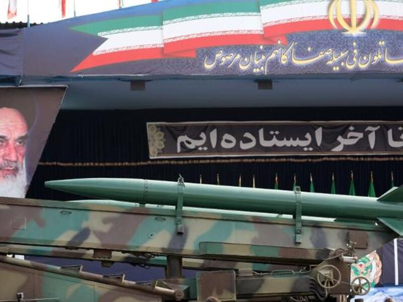  An Iranian surface to surface Zelzal missile is driven past portraits of Iran's late founder of the Islamic republic, Ayatollah Khomeini . (Image credit: Getty)