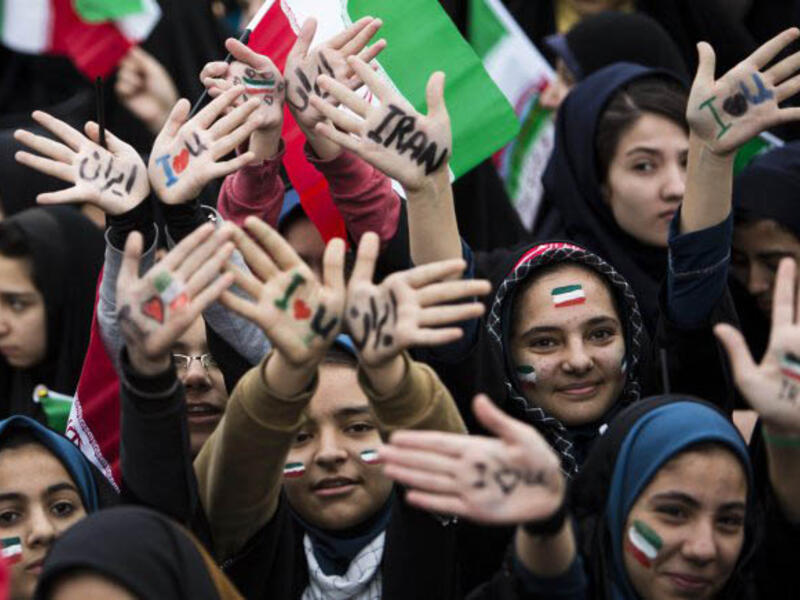 Iranian schoolgirls celebrate the 36th anniversary of the Islamic Revolution in Tehran. (AFP/File)