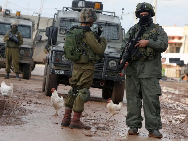 Israeli soldiers are seen during clashes with Palestinian protestors in the village of Qabatiya, near the West Bank town of Jenin on February 22, 2016. (AFP/Jaafar Ashtiyeh)