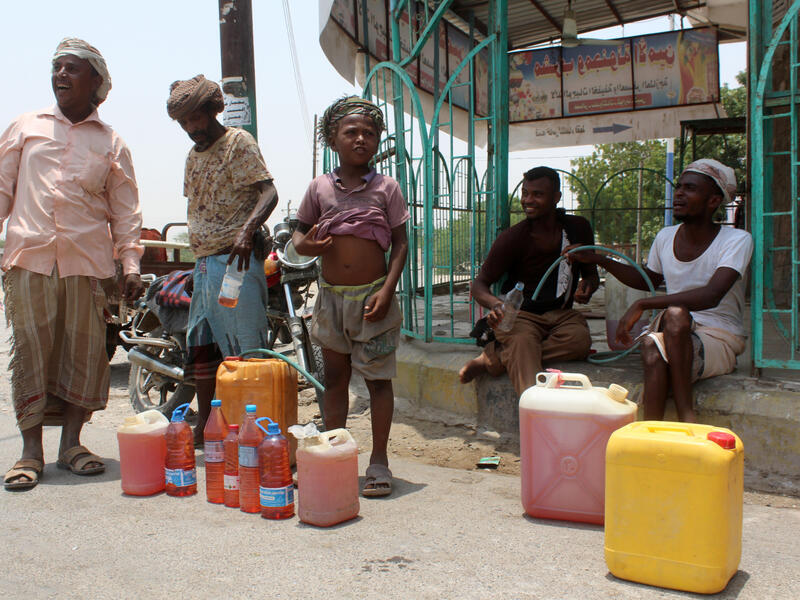 Yemenis sell petrol on the street after Yememi government forces re-entered Zinjibar the capital of the southern Abyan province on August 16, 2016 following an offensive backed by Saudi-led air strikes to recapture the city from Al-Qaeda jihadists. (Photo credit: AFP)