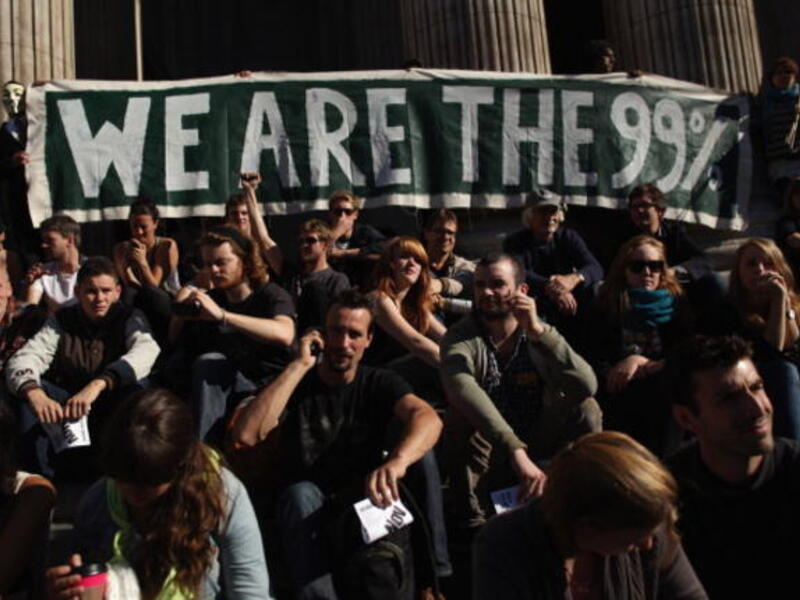Occupy London's Stock Exchange: headlined the UK's continental effort in a bout of peaceful protest
near St. Paul's this weekend. This assembly of happy campers marked the more familiar British spirit of
Wimbledon-style overnight queuing, as people expressed that this was civil disobedience, not protest. 
A far cry from London's Summer fire. 
