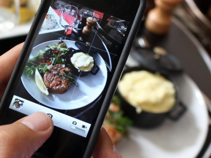 A man photographs his meal with a cell phone. Photograph by Ana Arevalo. AFP