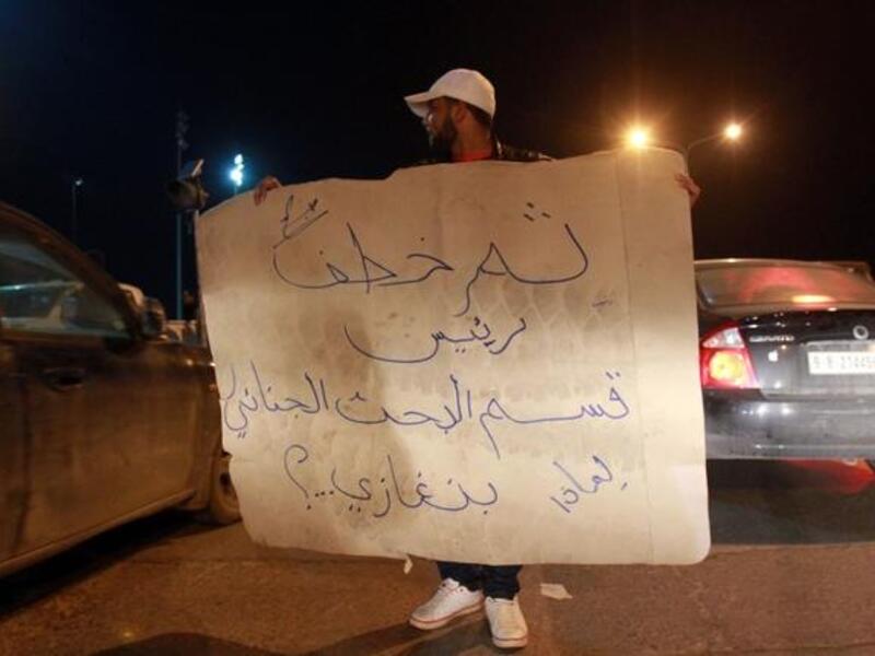 Libyan policemen in civilian clothing protest against the kidnapping of the Head of Criminal Investigation Department, Abdel Salam al-Mahdawi, outside the Tibesti hotel in Benghazi, on Thursday. (AFP PHOTO / ABDULLAH DOMA)