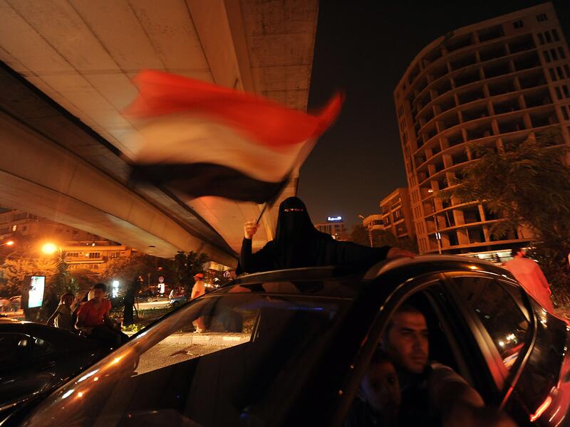An Egyptian female supporter of the deposed president Mohamed Morsi waves a national flag during a demonstration against the government in Cairo on July 31, 2013. (AFP)