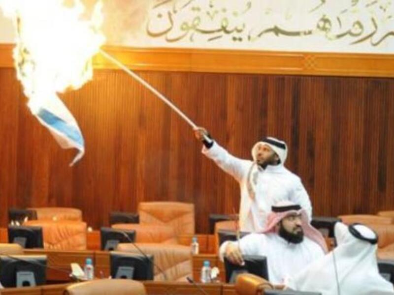 Osama Al Tamimi sets the Israeli flag on fire in Parliament.
