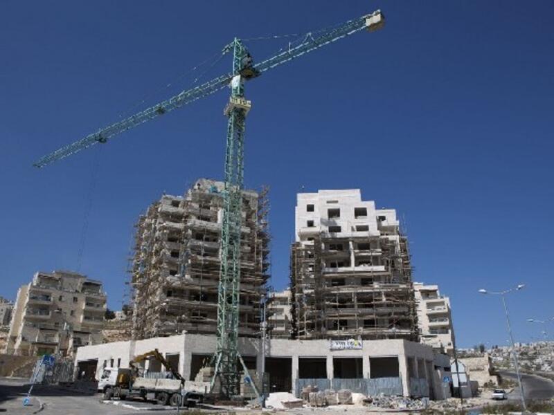 Labourers work on the construction of home in the Israeli settlement of Har Homa in Israeli annexed Arab East Jerusalem (file AFP)