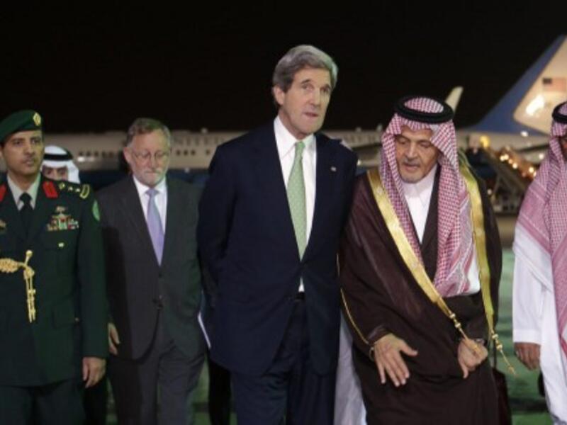 John Kerry is greeted by Saudi counterpart Prince Saud Al Faisal.