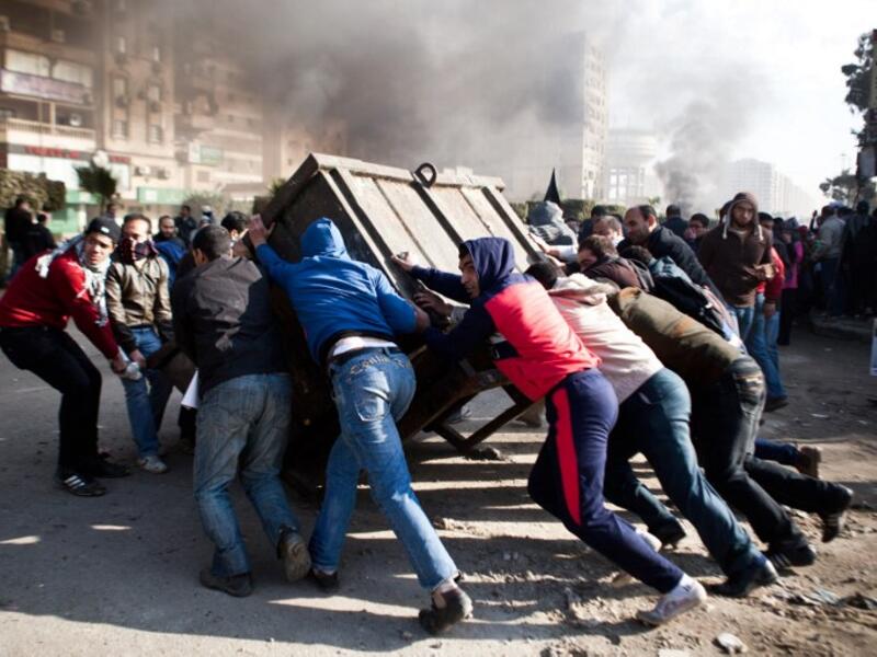 Supporters of ousted president Mohamed Morsi block a street during clashes with Egyptian security forces in Nasr City, Cairo on January 8, 2014. 63 Brotherhood supporters were sentenced to three years in prison on Thursday in a Cairo court. (AFP)
