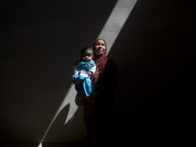 Amina, a Syrian woman who fled the fighting in Aleppo, is photographed inside an abandoned building with her five-month-old sick daughter, Asma, on the outskirts of Saraqib, southwest of Aleppo, on September 9, 2013. According to the Red Cross, more than one million Syrians are going hungry. (AFP)
