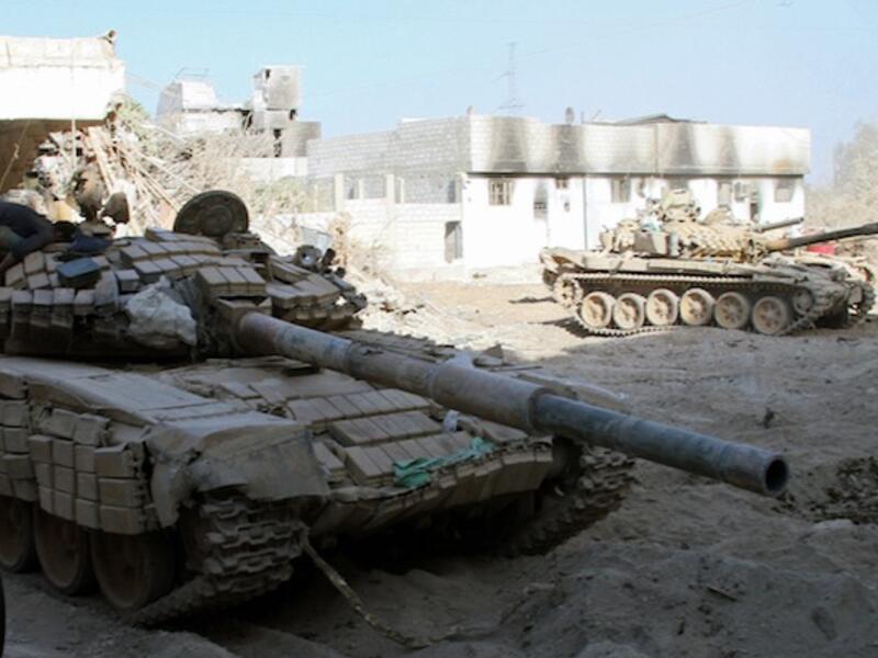 Syrian army tanks are seen deployed in the Jobar neighbourhood of Damascus on August 24, 2013. (AFP)