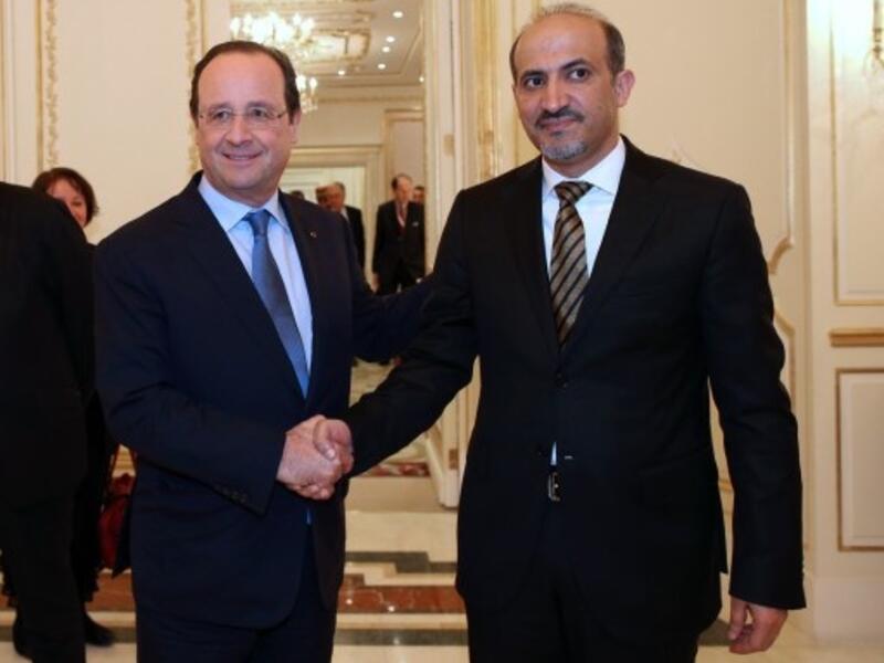Syrian opposition leader Ahmad Jarba met with French president Francois Hollande earlier this week in Saudi Arabia. The opposition leader has not yet confirmed his group's participation in the Swiss peace conference scheduled for January (Kenzo Tribouillard/AFP)