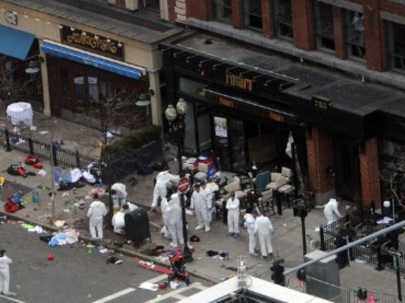 Investigators in white jumpsuits work the crime scene on Boylston Street following Monday's bomb attack at the Boston Marathon. (Photo: Darren McCollester/Getty Images/AFP)