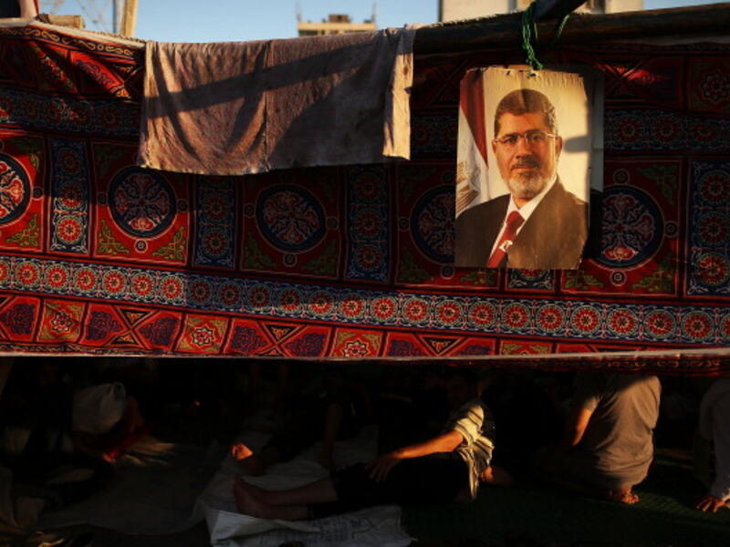 A picture of Mohamed Morsi hangs from a supporter's tent on July 10, 2013. (source: Getty / Spencer Platt)