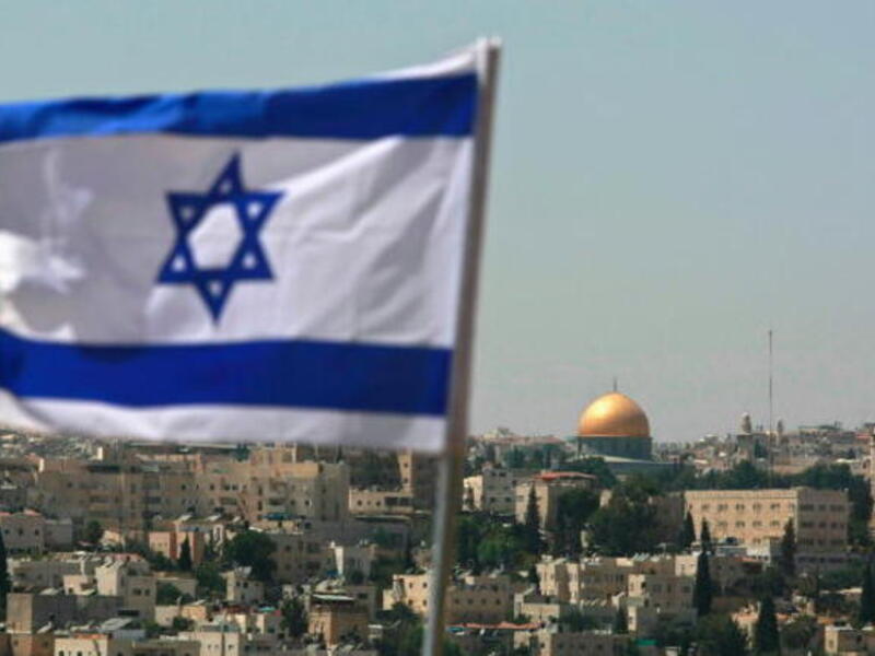 The Israeli flag is seen in front of the Dome of the Rock, in occupied Jerusalem. (Al Bawaba/File)