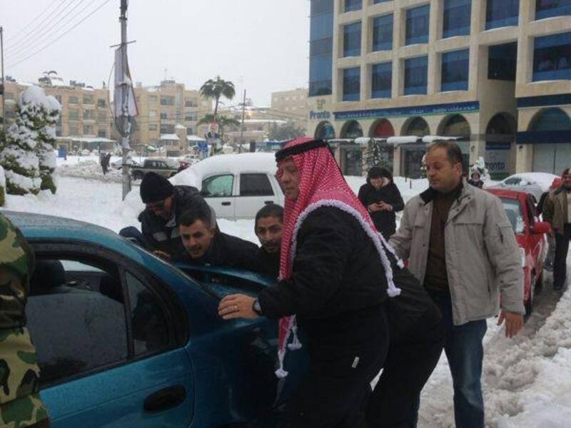Jordan's King Abdullah went to the streets Saturday to help residents dig their cars out from layers of snow that has trapped many people throughout the Kingdom (Courtesy of Jordan Times)