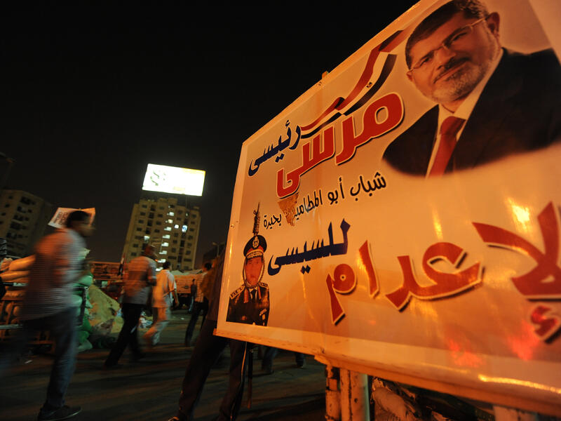 A protest sign showing deposed president Mohamed Morsi hangs in Cairo on July 31. (AFP / Fayez Nureldine)