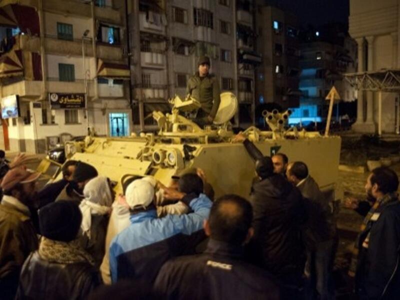 Egyptian protestors shout at a soldier standing in an armored personnel carrier as they demonstrate in the streets of the canal city of Port Said in late January (Photo: AFP / STR)