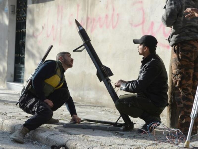 Syrian rebels fire a mortar towards regime forces stationed at Kwiriss airport in Al-Bab, 30 kilometres from the northeastern Syrian city of Aleppo, on Thursday. (AFP Photo/Edouard Elias)