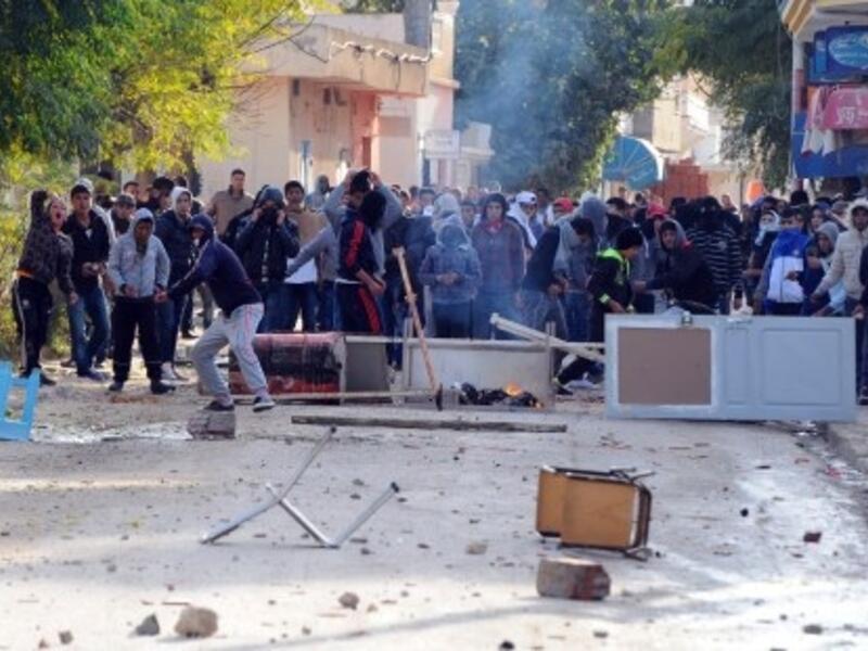 Tunisian protestors hurled stones at security officials late last week, calling for the ruling Islamist party Ennahda's resignation (Fethi Balaid/AFP)
