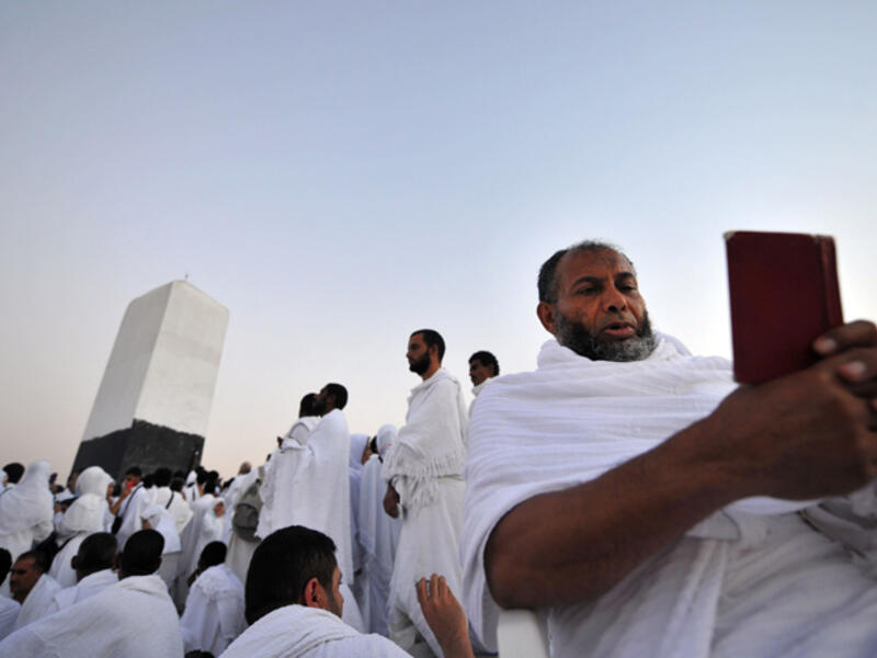 A Muslim pilgrim reads the Quran on top of Mount Arafat in Mecca ahead of the Hajj pilgrimage. (AFP/File)
