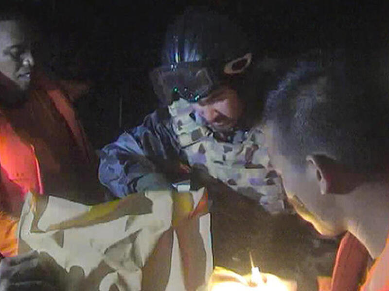 Members of the Australian navy look for survivors from a boat carrying Middle Eastern asylum seekers. At least 22 people have died, most of them children. (Image credit: AFP)