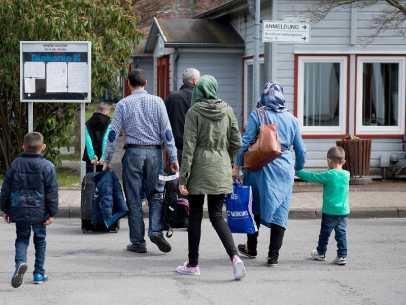 Refugees from Syria arrive at the Friedland shelter near Goettingen, central Germany, on April 4, 2016, after arriving from Turkey at the airport in Hanover. (AFP/Swen Pfoertner)