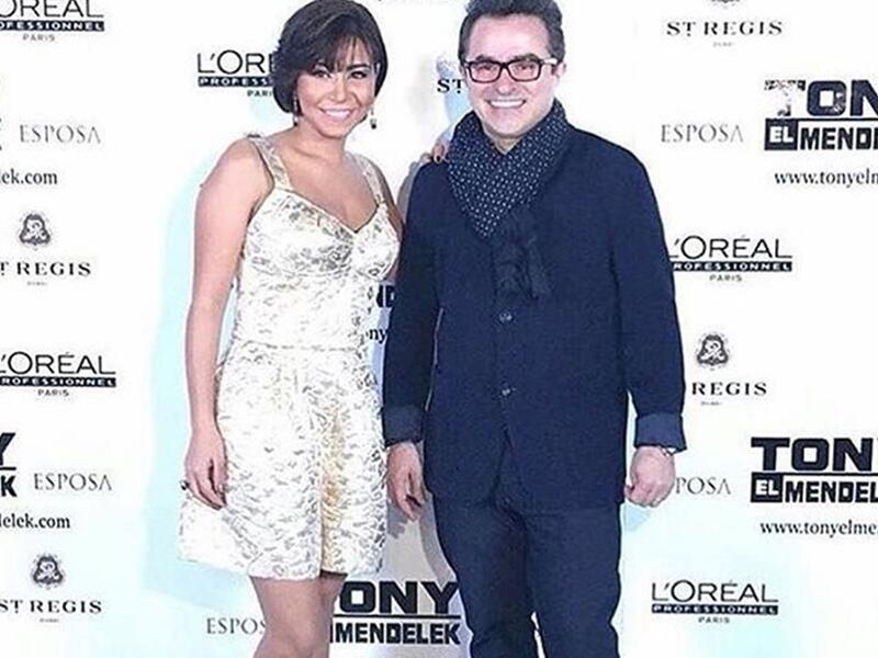 لبت شيرين عوة مصفف الشعر اللبناني طوني المندلق للاحتفال بافتتاح صالونه في دبي مرتدية Jumpsuit شورت من Dolce & Gabbana بقماش الديباج الموشى بخيوط ذهبية وفضية ونسقت مع زيها حذاء من كريستيان لوبوتان طلة شيرين وصفت بالجريئة وانقسمت الآراء بين معجب ومنتقد لها