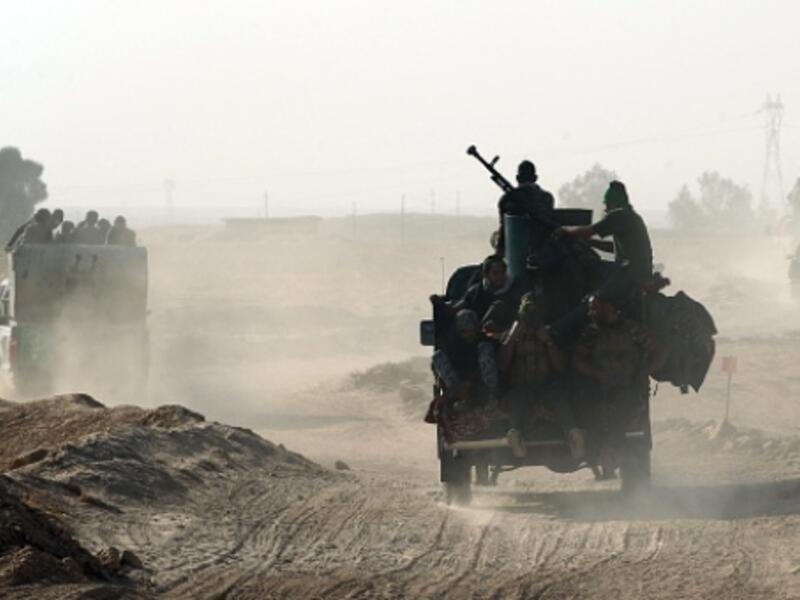 Shia fighters from the Popular Mobilization Forces arrive south of Mosul as part of the largest military operation in Iraq in years. (AFP/File)