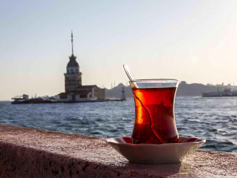 A cup of Turkish tea on the background of the Maiden Tower. (Shutterstock)
