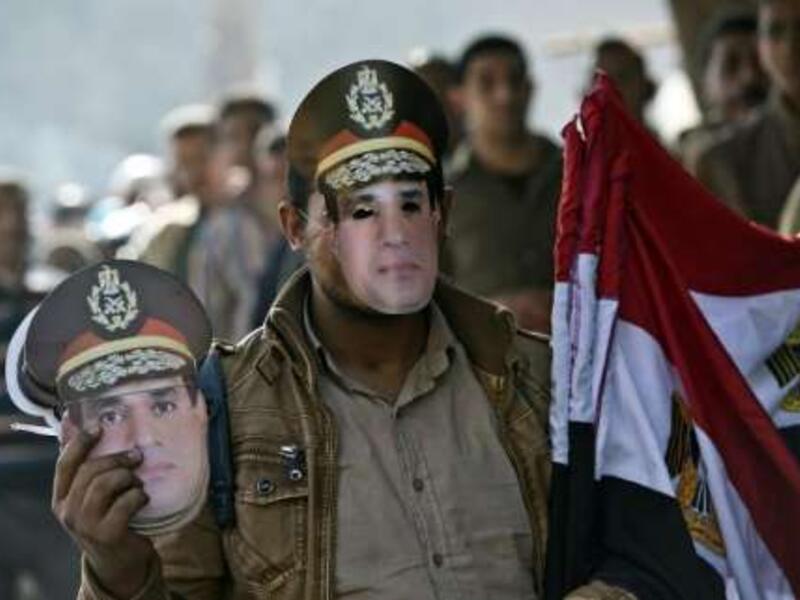 An Egyptian street vendor sells the country's national flag and masks of Egypt's, then Defence Minister but now current president, General Abdel Fattah al-Sisi. (AFP/File)