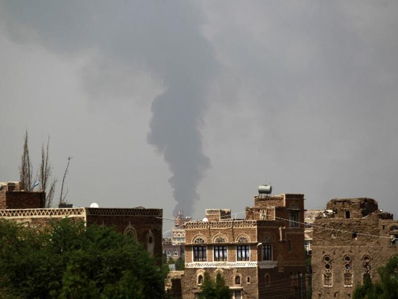 Smoke billows from a building hit by a Saudi-coalition airstrike on August 10, 2016. (AFP/Mohammed Huwais)