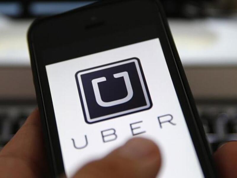 The Uber app being used on a cell phone (File photo)