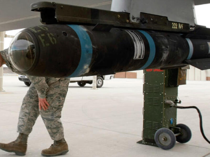 US soldier walks around an inert Hellfire missile as he perform a pre-flight check on an MQ-1B Predator unmanned aircraft system. [AFP]