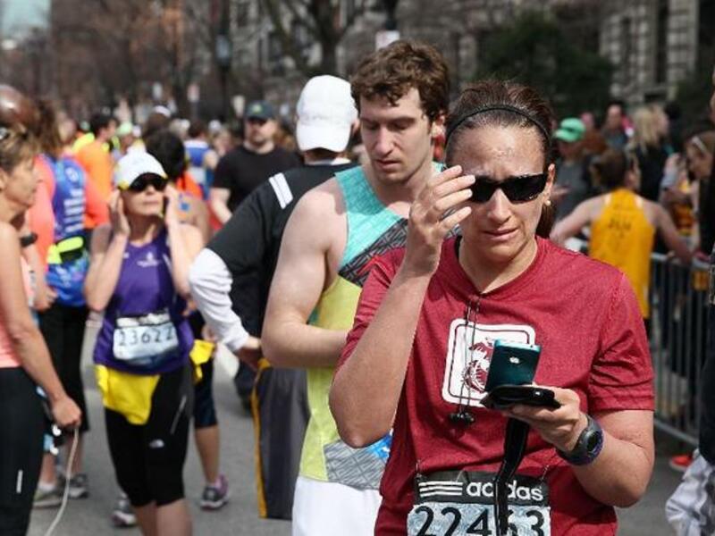 A woman reacts after two explosions rock the Boston Marathon (AFP/ Alex Trautwig)