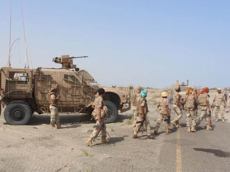 Yemeni Loyalist fighters walk through a town in southern Yemen after battling with Al-Qaeda militants on August 14, 2016. (AFP/Saleh al-Obeidi)