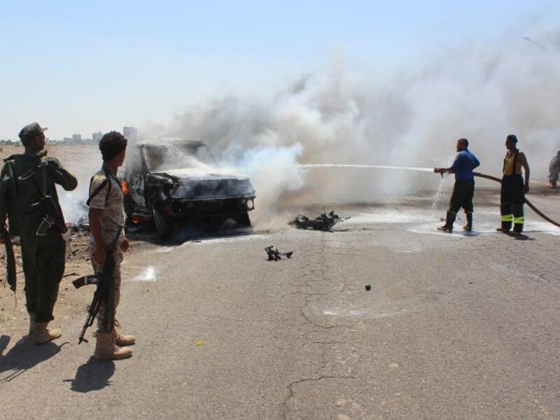Yemenis gather at the site of a twin bombing that targeted Yemeni forces in the southern city of Aden on May 23, 2016. (AFP/Saleh al-Obeidi)